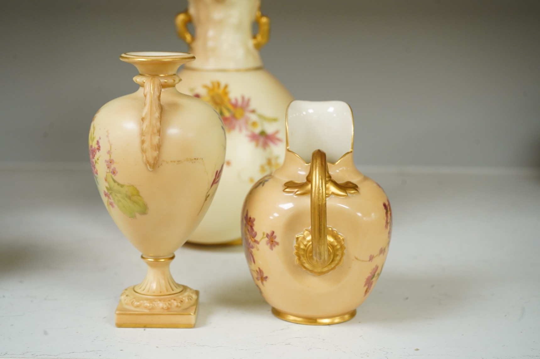 Three pieces of Royal Worcester blush ivory porcelain vessels, tallest 20cm